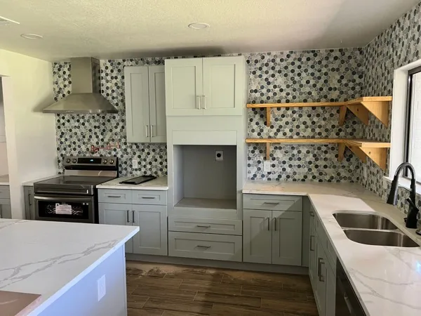 white kitchen with patterned backsplash and gold faucet by WoodArt Cabinets San Antonio