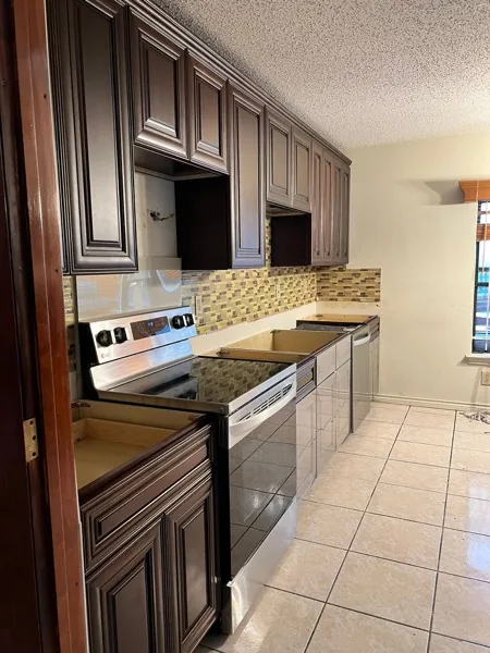 espresso shaker kitchen with granite counters and tile floor by WoodArt Cabinets San Antonio