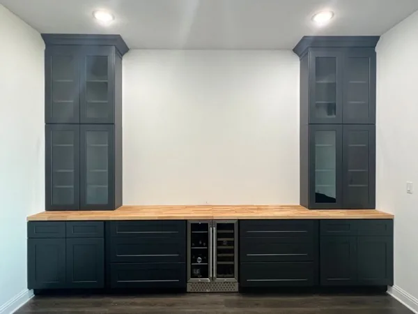 Navy cabinets with glass uppers and wine fridge by WoodArt Cabinets San Antonio