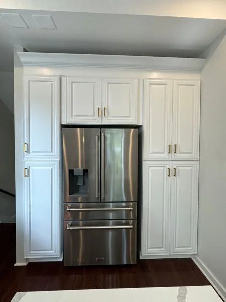 white kitchen with stainless refrigerator wall by WoodArt Cabinets San Antonio