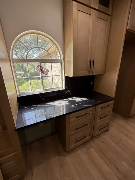 white kitchen with dark island in Alamo Heights by WoodArt Cabinets San Antonio