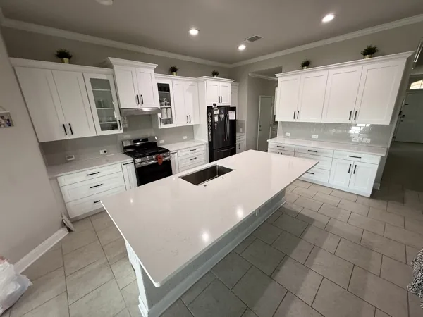 white kitchen with quartz island in New Braunfels by WoodArt Cabinets San Antonio